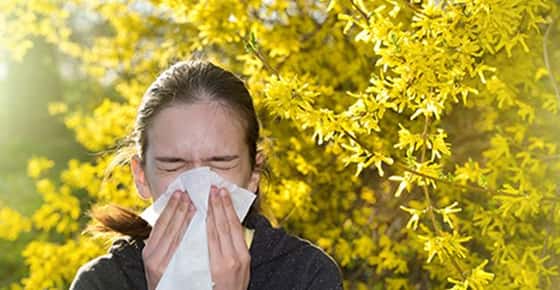 Image of woman blowing her nose.