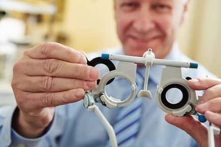 Image of doctor with eye equipment.