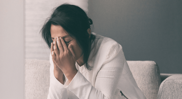 Stressed woman sitting on couch