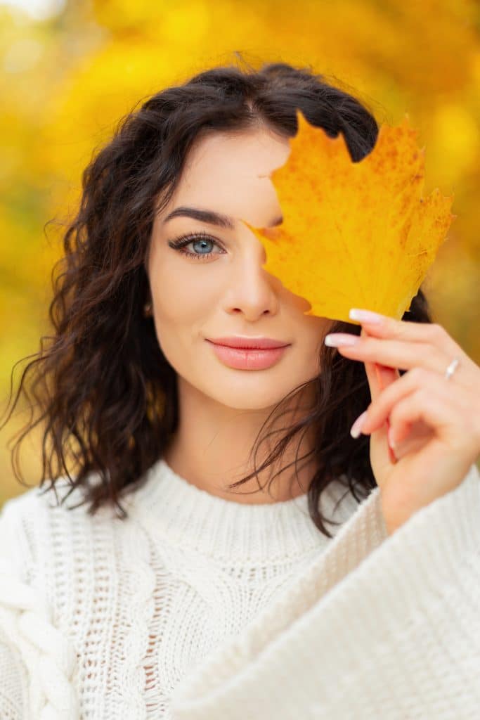 Woman enjoying smooth skin after a soothing autumn facial and IPL rosacea treatment.